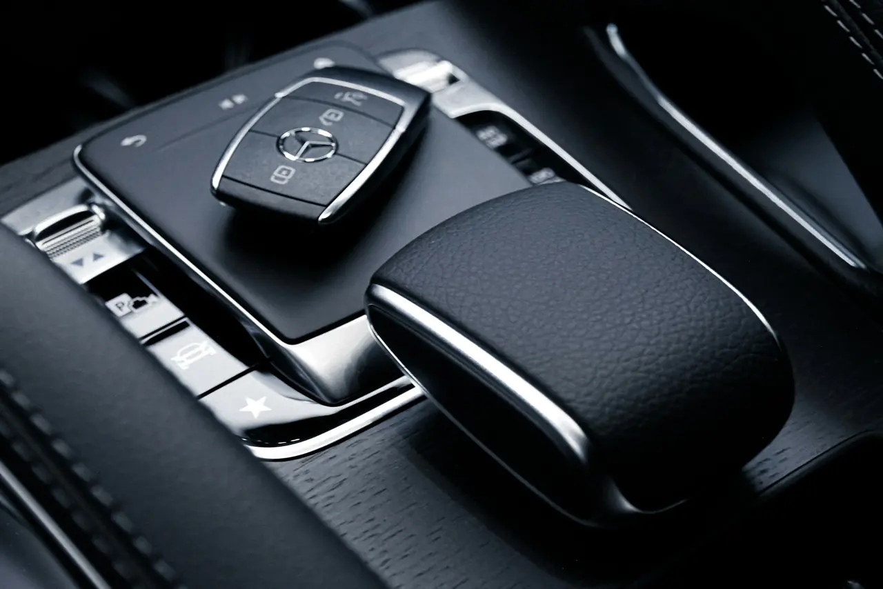 A Mercedes-Benz key resting on a centre console